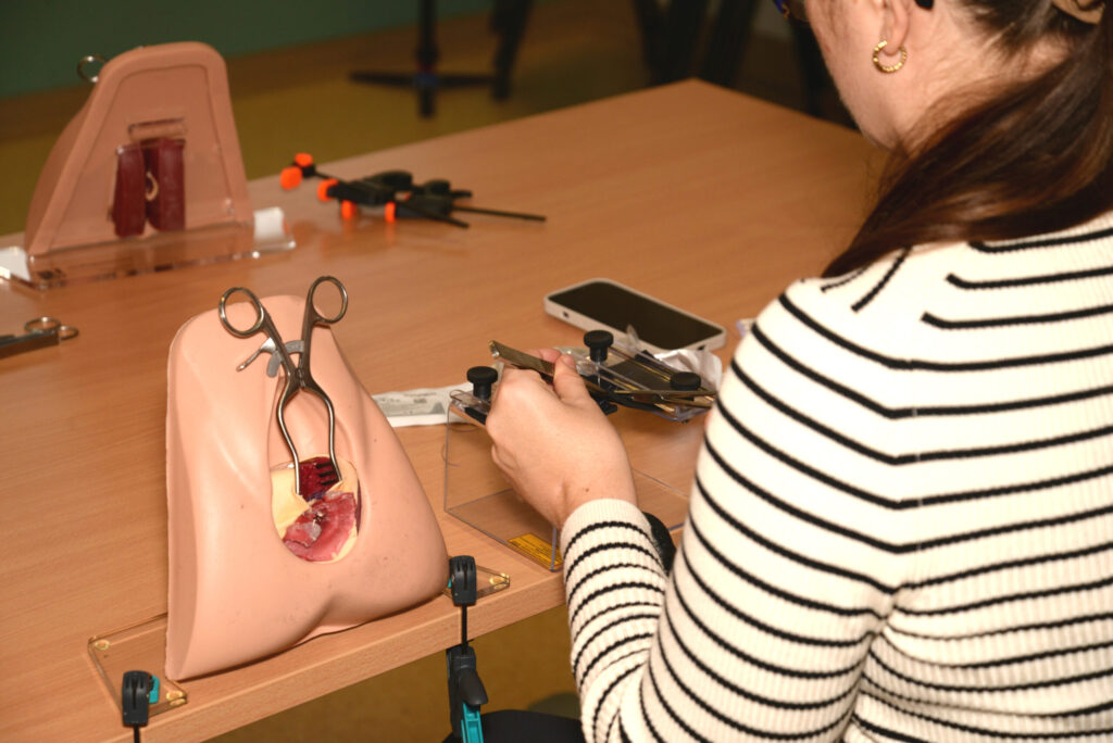 A perineal trainer model with instruments during practice