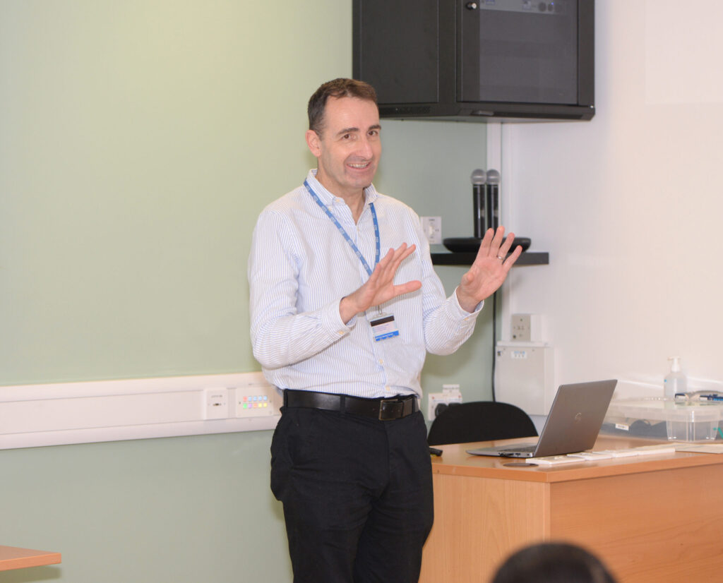 A speaker presenting to delegates